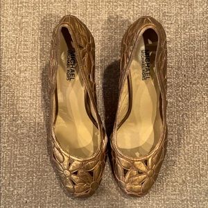 Michael Michael Kors Gold cut out floral shoes.